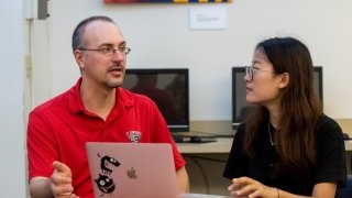 St. Lawrence Professor discussing a topic with a student.
