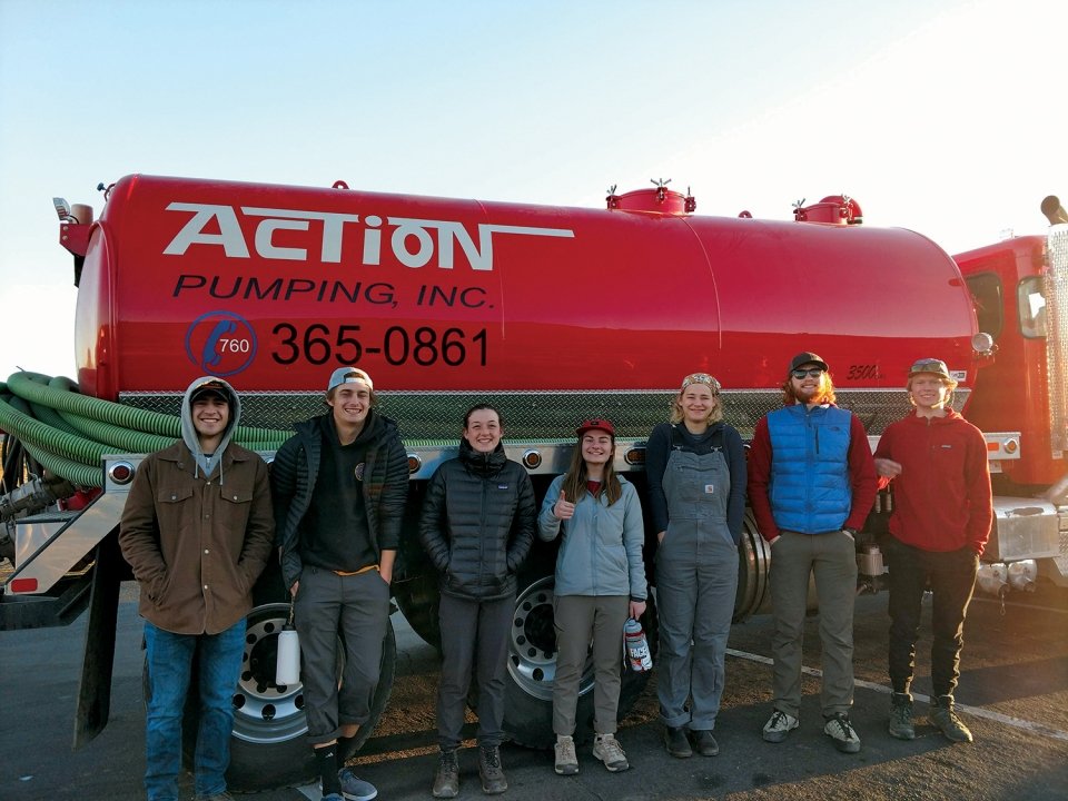 A photo of Modern Outdoor Recreation Ethics students standing outside a truck.