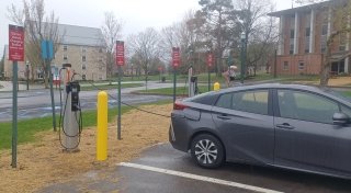 A car plugged into the electric vehicle charging station at the Vila's Hall parking lot.