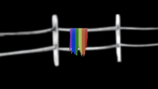 Image of a split rail fence with a torn PRIDE flag