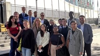 Group of students posing at the main entrance of the UN headquarters