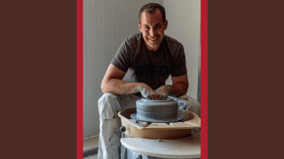 Christopher Spitzmiller leans over a pottery wheel and works on his latest project.