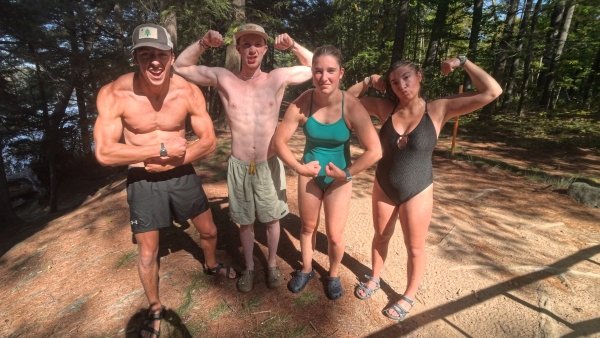 Swimmers pose while their partners complete the final stretch.