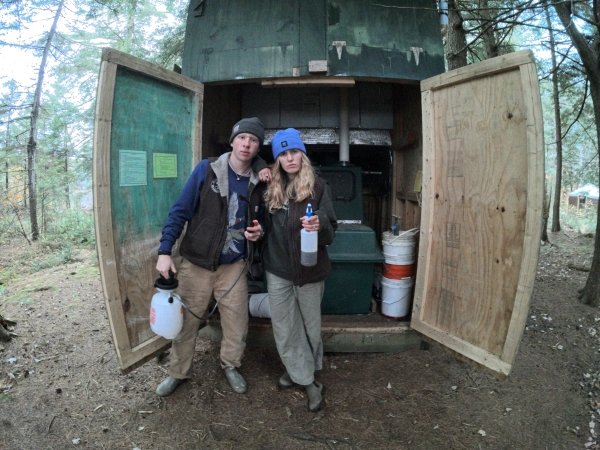 Chore partners Hannah and Roy pose in front of a freshly cleaned Clive.