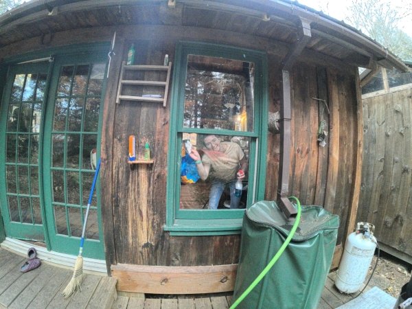 Clara cleans the windows of the kitchen.