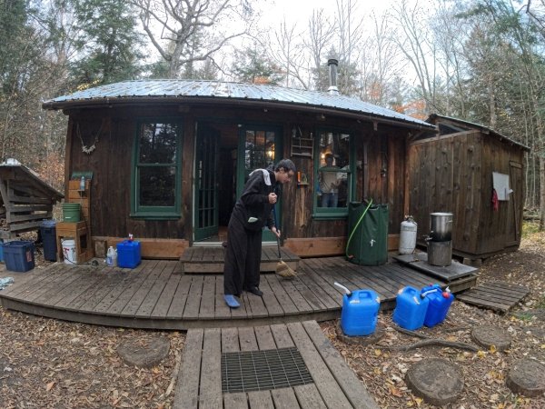 Megan Uribe sweeps the kitchen porch.