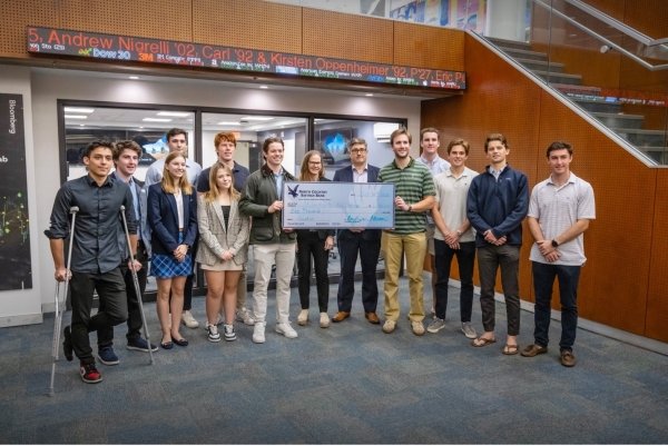 President and CEO of North Country Saving Bank R. Brian Coakley P’26, P’27, presented a check for $1,000 to support the Federal Reserve Challenge course. 