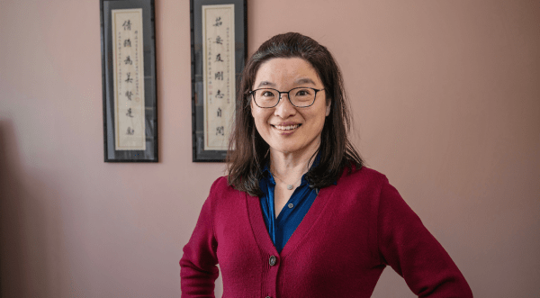 Grace Huang wearing a scarlet sweater.